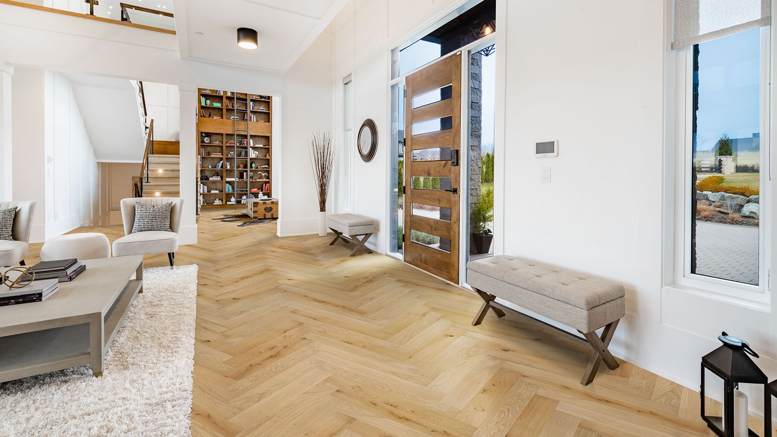 Large open concept great room with fireplace and wooden beams